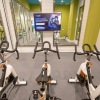 Open and well-lit fitness center with spin class